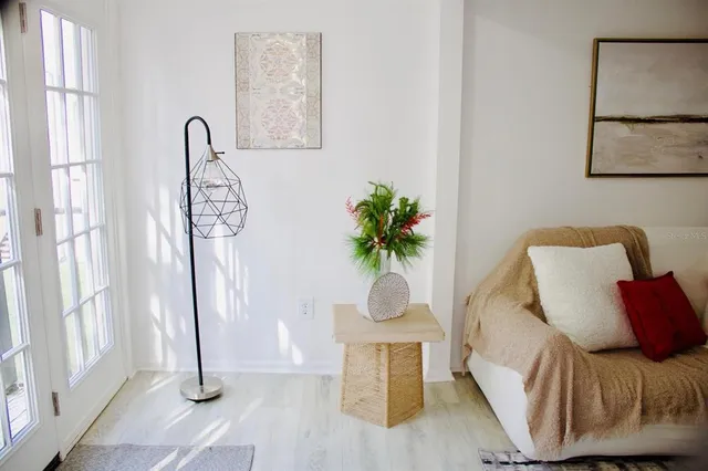 a living room with furniture and a potted plant