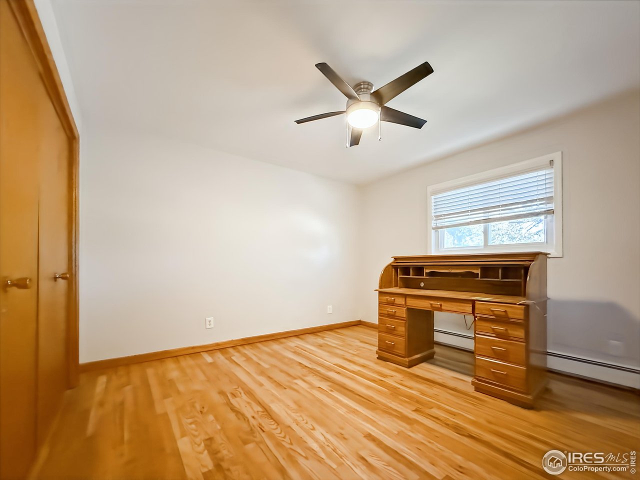 1695 6th Street Limon, CO 80828 - Photo 13 of 32 a view of a livingroom with wooden floor and a ceiling fan