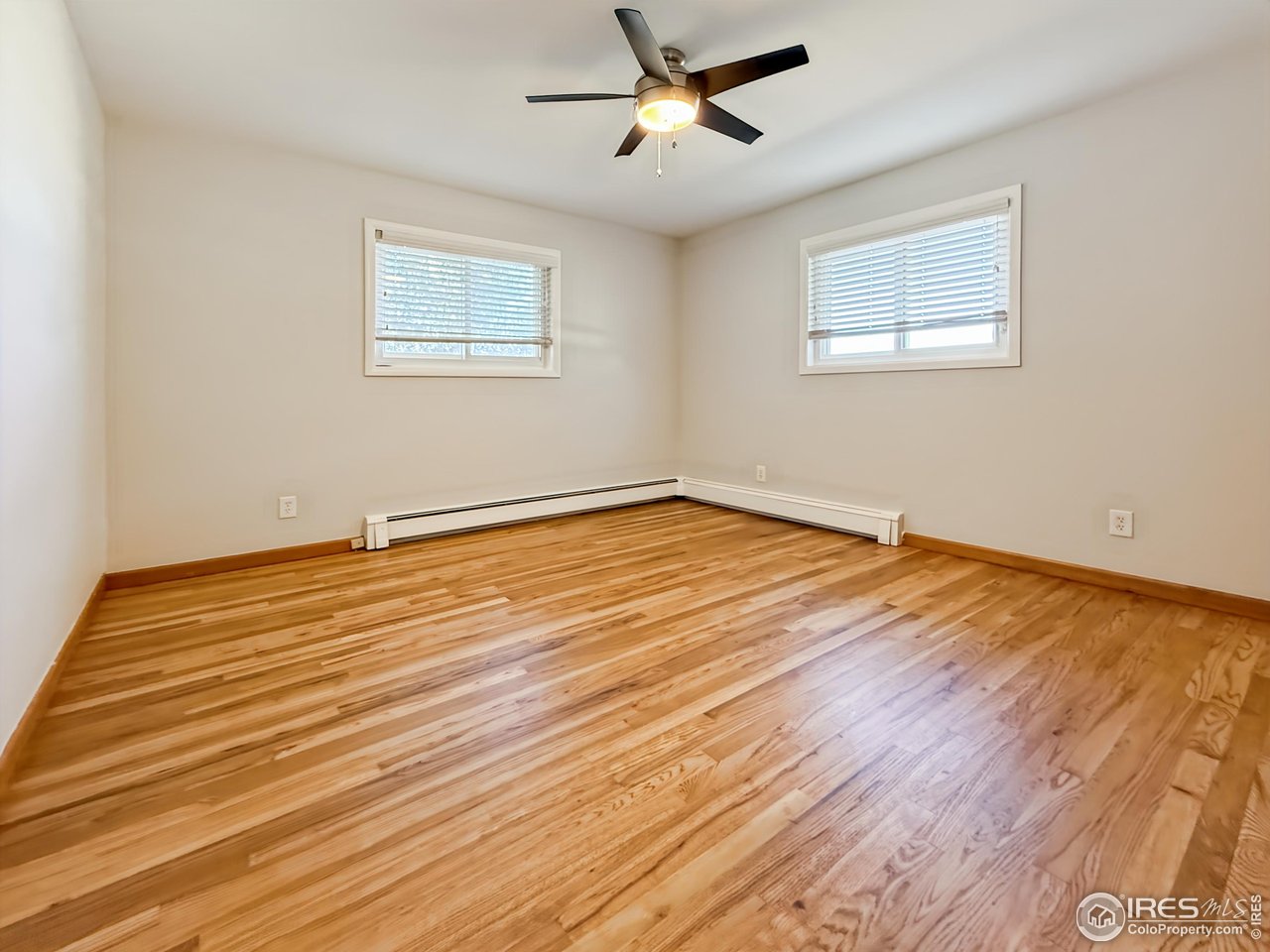 1695 6th Street Limon, CO 80828 - Photo 14 of 32 a view of empty room with wooden floor and fan