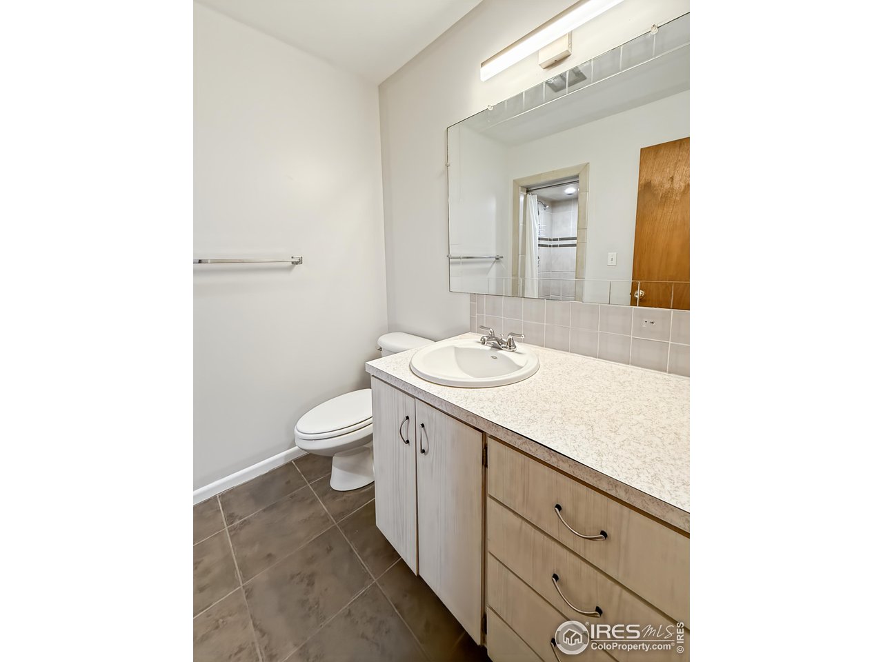 1695 6th Street Limon, CO 80828 - Photo 16 of 32 a bathroom with a sink a toilet and mirror