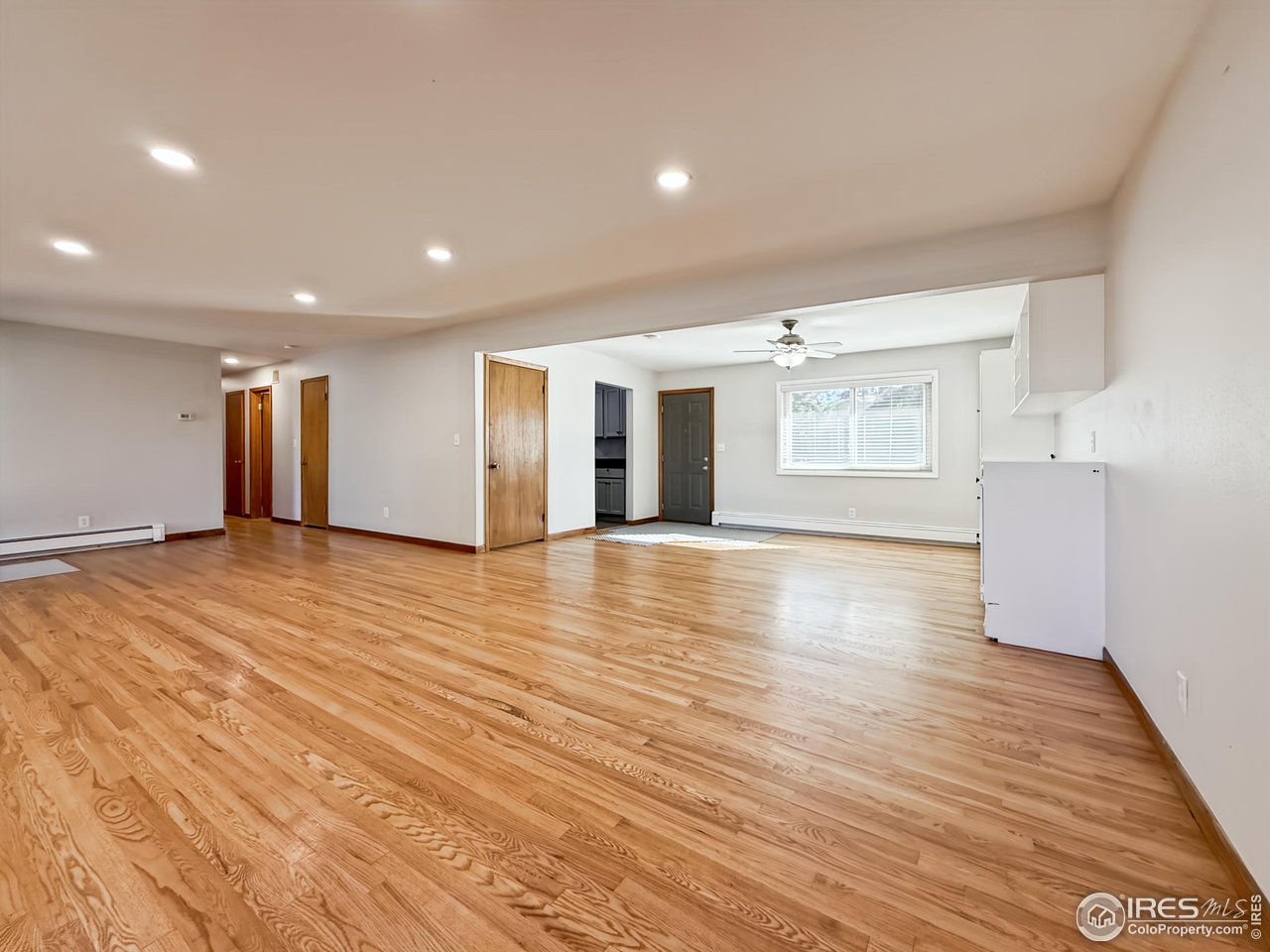 1695 6th Street Limon, CO 80828 - Photo 2 of 32 a view of empty room with wooden floor and kitchen view