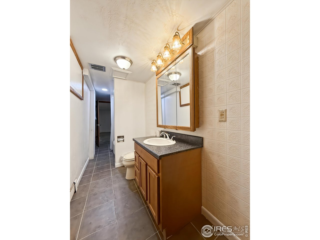 1695 6th Street Limon, CO 80828 - Photo 25 of 32 a kitchen with stainless steel appliances granite countertop a stove and a refrigerator