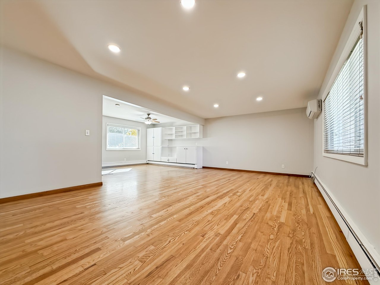 1695 6th Street Limon, CO 80828 - Photo 3 of 32 a view of an empty room with wooden floor and a window