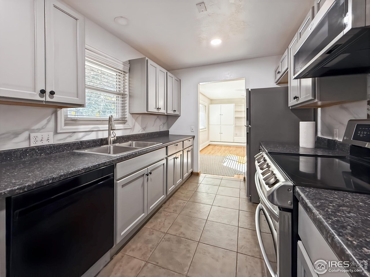 1695 6th Street Limon, CO 80828 - Photo 6 of 32 a kitchen with stainless steel appliances granite countertop a sink stove and cabinets