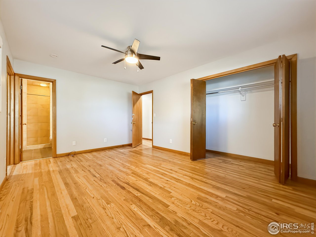 1695 6th Street Limon, CO 80828 - Photo 7 of 32 a view of empty room with wooden floor and fan
