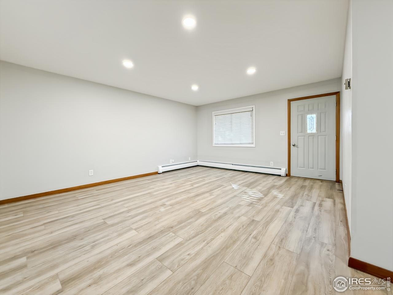 1695 6th Street Limon, CO 80828 - Photo 9 of 32 an empty room with wooden floor and windows