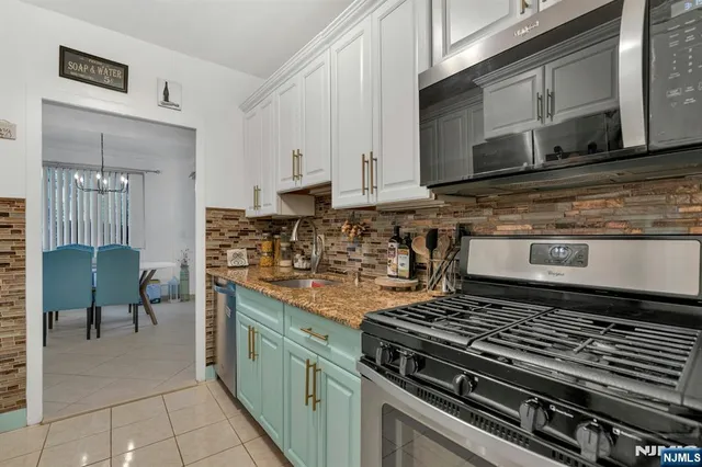 a kitchen with stainless steel appliances granite countertop a stove and a microwave