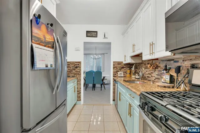 a kitchen with stainless steel appliances granite countertop a stove and a refrigerator