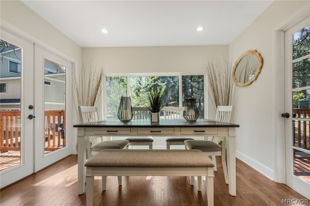 195 Elgin Road Big Bear Lake, CA 92315 - Photo 7 of 45 a dining room with wooden floor a glass table and chairs