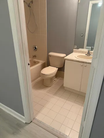a white toilet sitting next to a bathroom sink