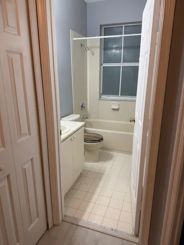 a bathroom with a sink a toilet and a shower
