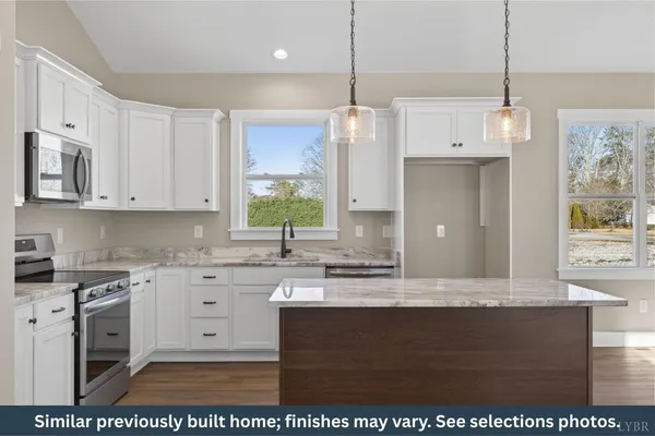 a kitchen with stainless steel appliances granite countertop a sink a stove a microwave a counter top and cabinets