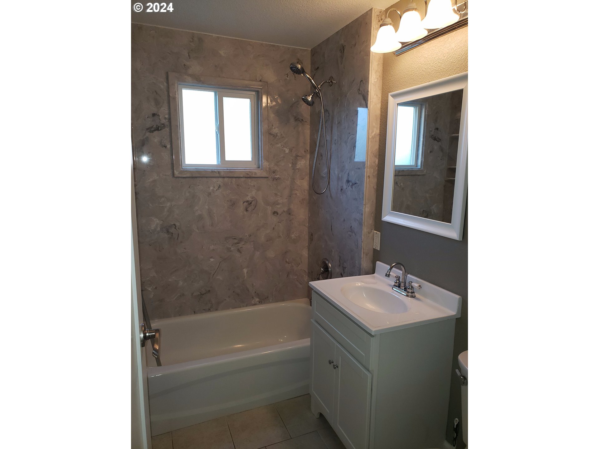 395 Irving Road Eugene, OR 97404 - Photo 17 of 37 a bathroom with a tub sink vanity and mirror