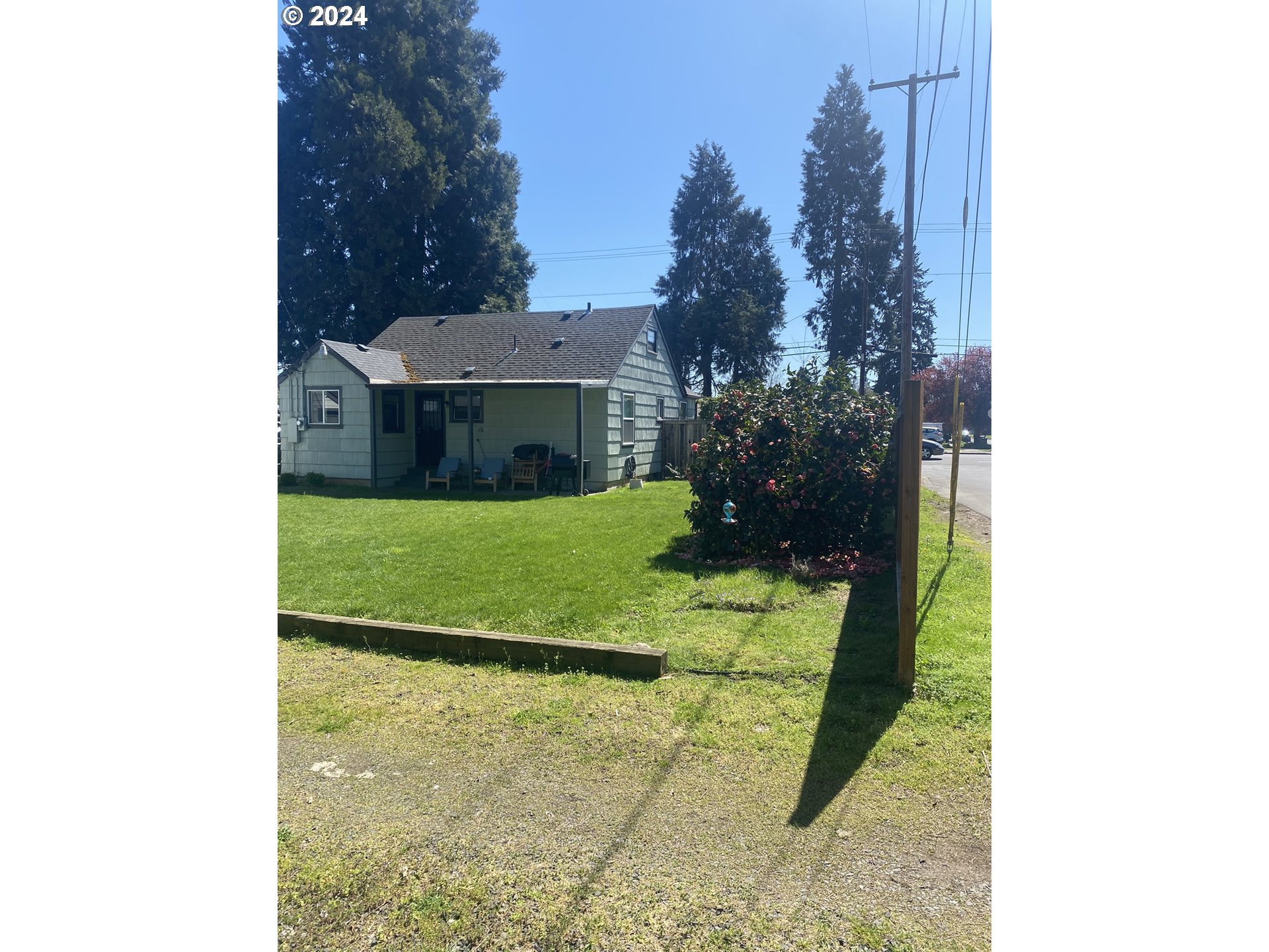 395 Irving Road Eugene, OR 97404 - Photo 26 of 37 a view of a house with a backyard and a garden