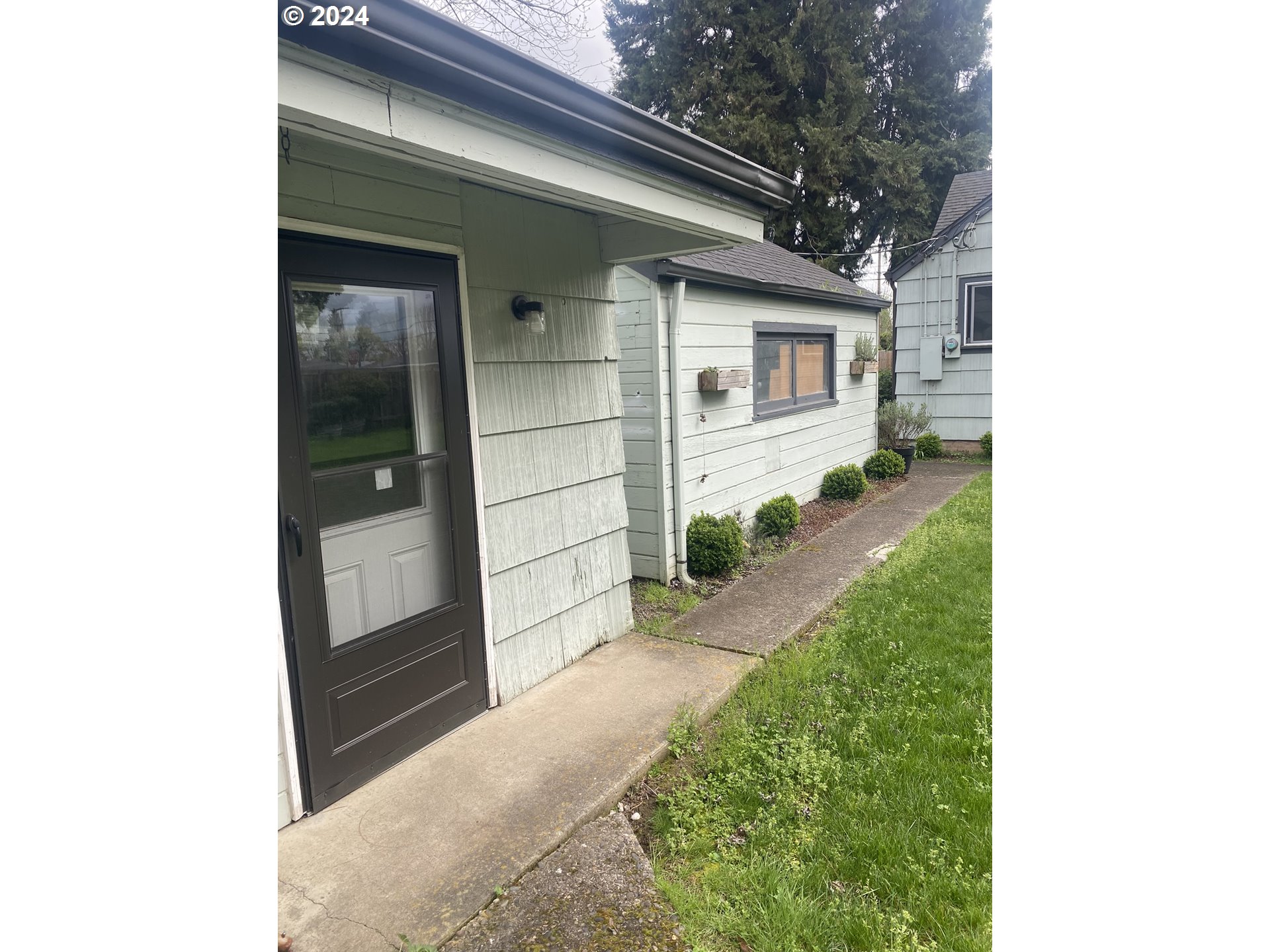 395 Irving Road Eugene, OR 97404 - Photo 28 of 37 a front view of a house with a yard