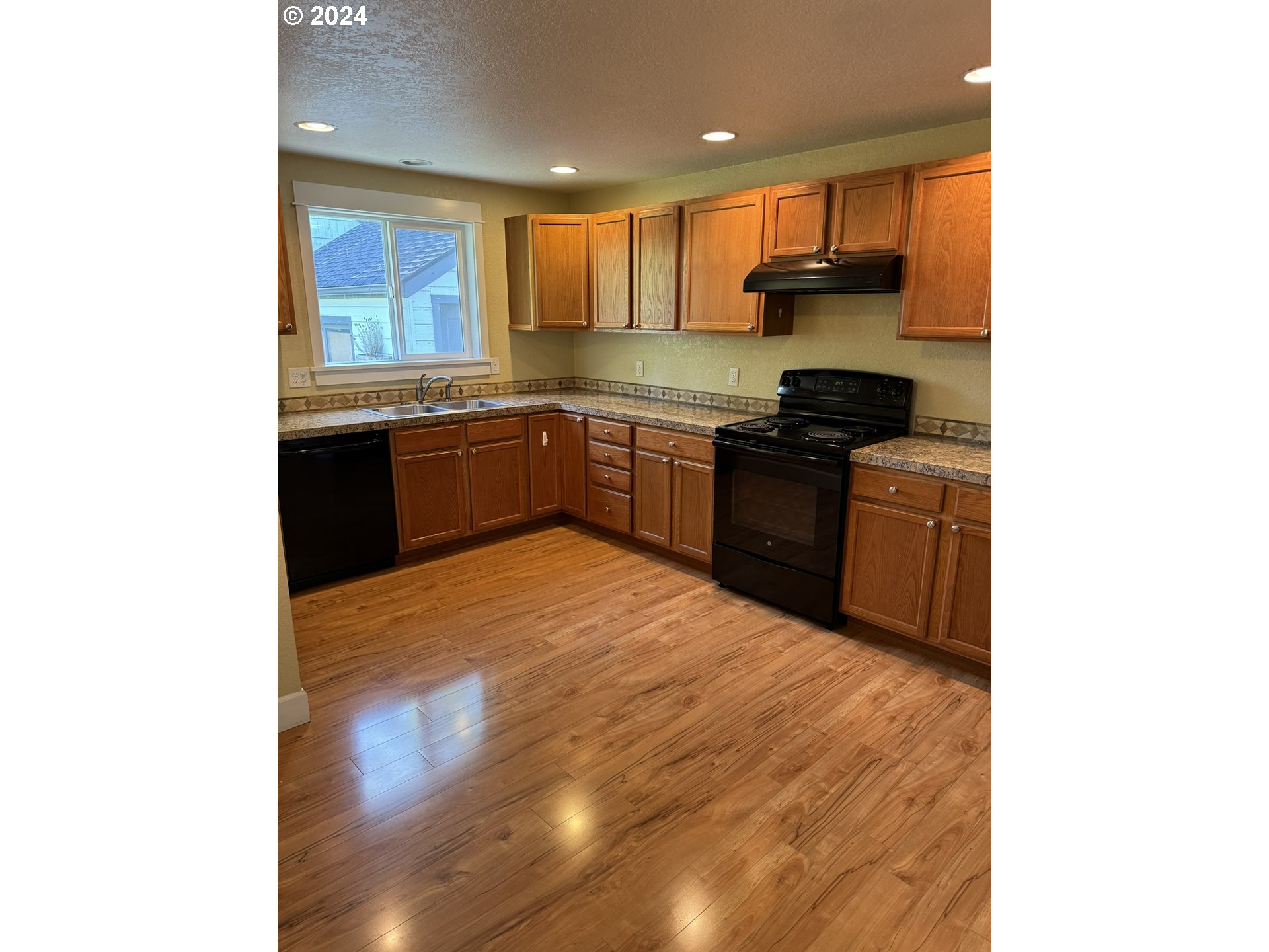 395 Irving Road Eugene, OR 97404 - Photo 5 of 37 a kitchen with stainless steel appliances granite countertop a stove a sink and a refrigerator