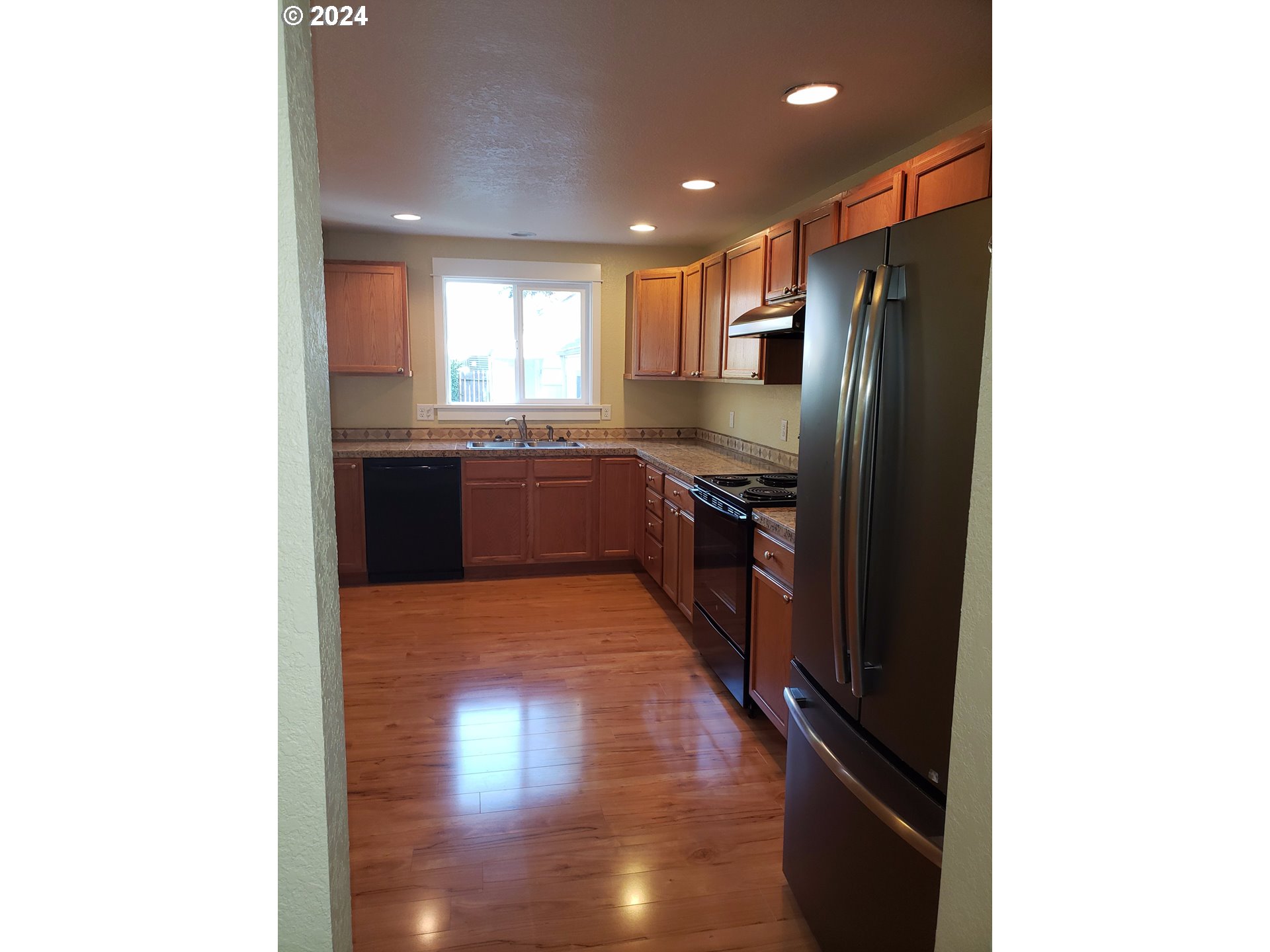 395 Irving Road Eugene, OR 97404 - Photo 6 of 37 a large kitchen with stainless steel appliances granite countertop a refrigerator and a stove