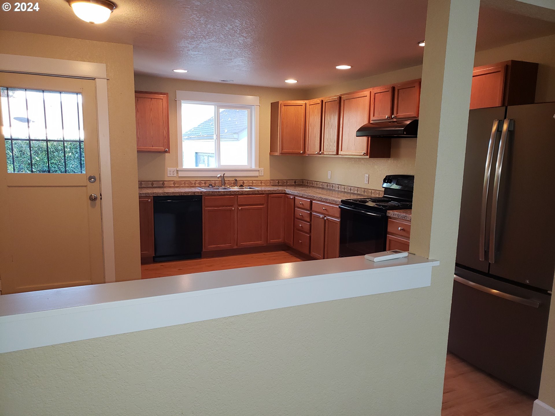 395 Irving Road Eugene, OR 97404 - Photo 7 of 37 a large kitchen with stainless steel appliances granite countertop a refrigerator a sink dishwasher a stove and a refrigerator