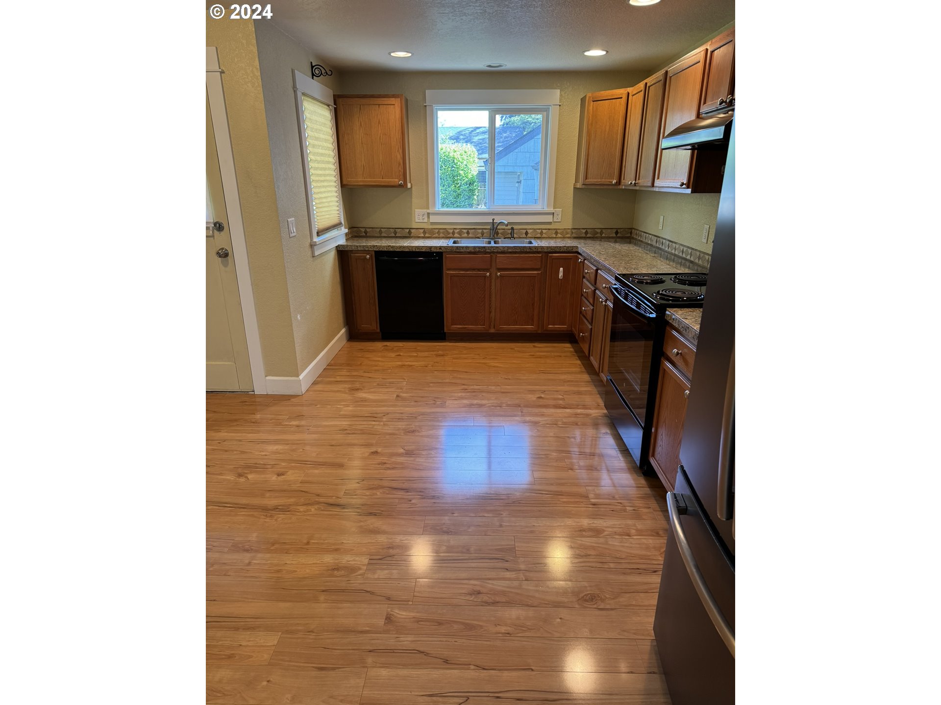 395 Irving Road Eugene, OR 97404 - Photo 8 of 37 a kitchen with stainless steel appliances granite countertop a stove and a refrigerator