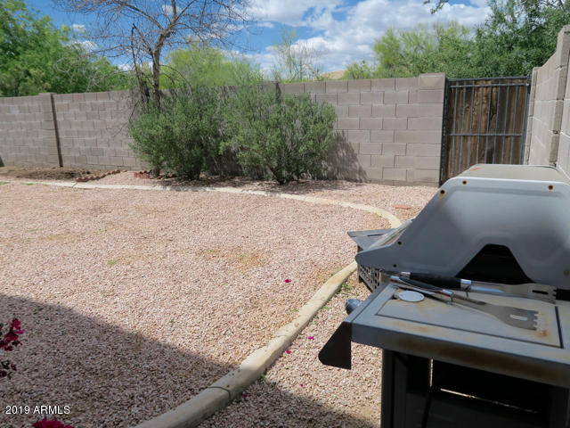10442 East Butte Street Apache Junction, AZ 85120 - Photo 17 of 49 a view of a backyard with a bench