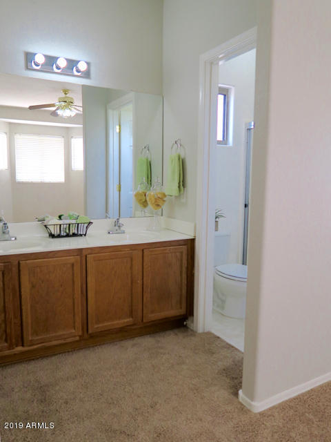 10442 East Butte Street Apache Junction, AZ 85120 - Photo 23 of 49 a bathroom with a granite countertop sink and a mirror