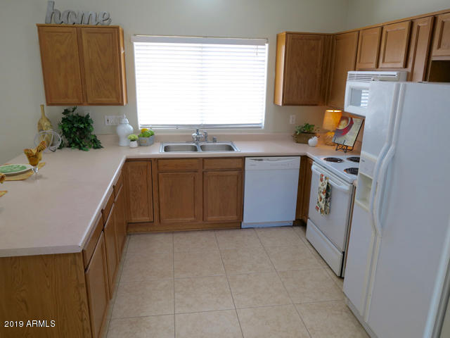 10442 East Butte Street Apache Junction, AZ 85120 - Photo 3 of 49 a kitchen with a refrigerator and a window