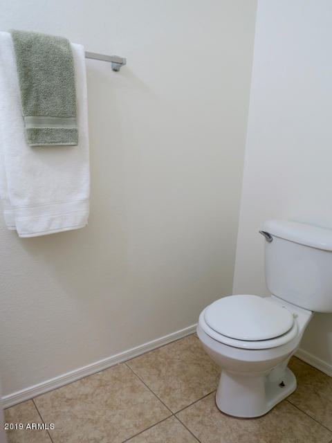 10442 East Butte Street Apache Junction, AZ 85120 - Photo 37 of 49 a white toilet sitting next to a white sink