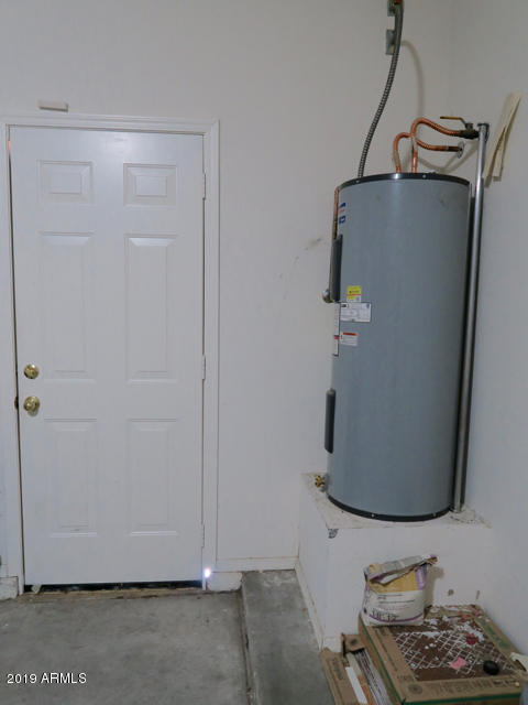 10442 East Butte Street Apache Junction, AZ 85120 - Photo 40 of 49 a room with water heater and cabinets