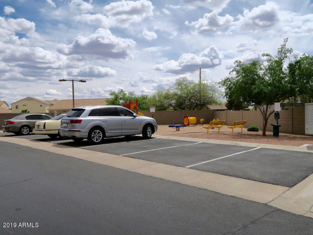 10442 East Butte Street Apache Junction, AZ 85120 - Photo 42 of 49 a view of a city street with a cars parked on the roadside