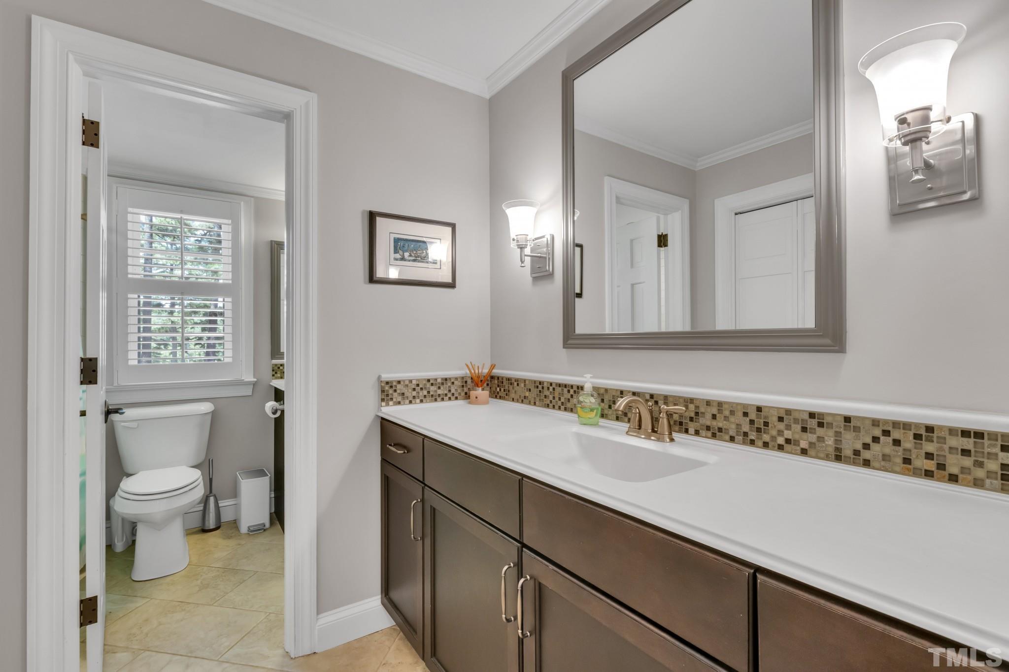 1617 Hunting Ridge Road Raleigh, NC 27615 - Photo 11 of 31 a bathroom with a sink and a toilet