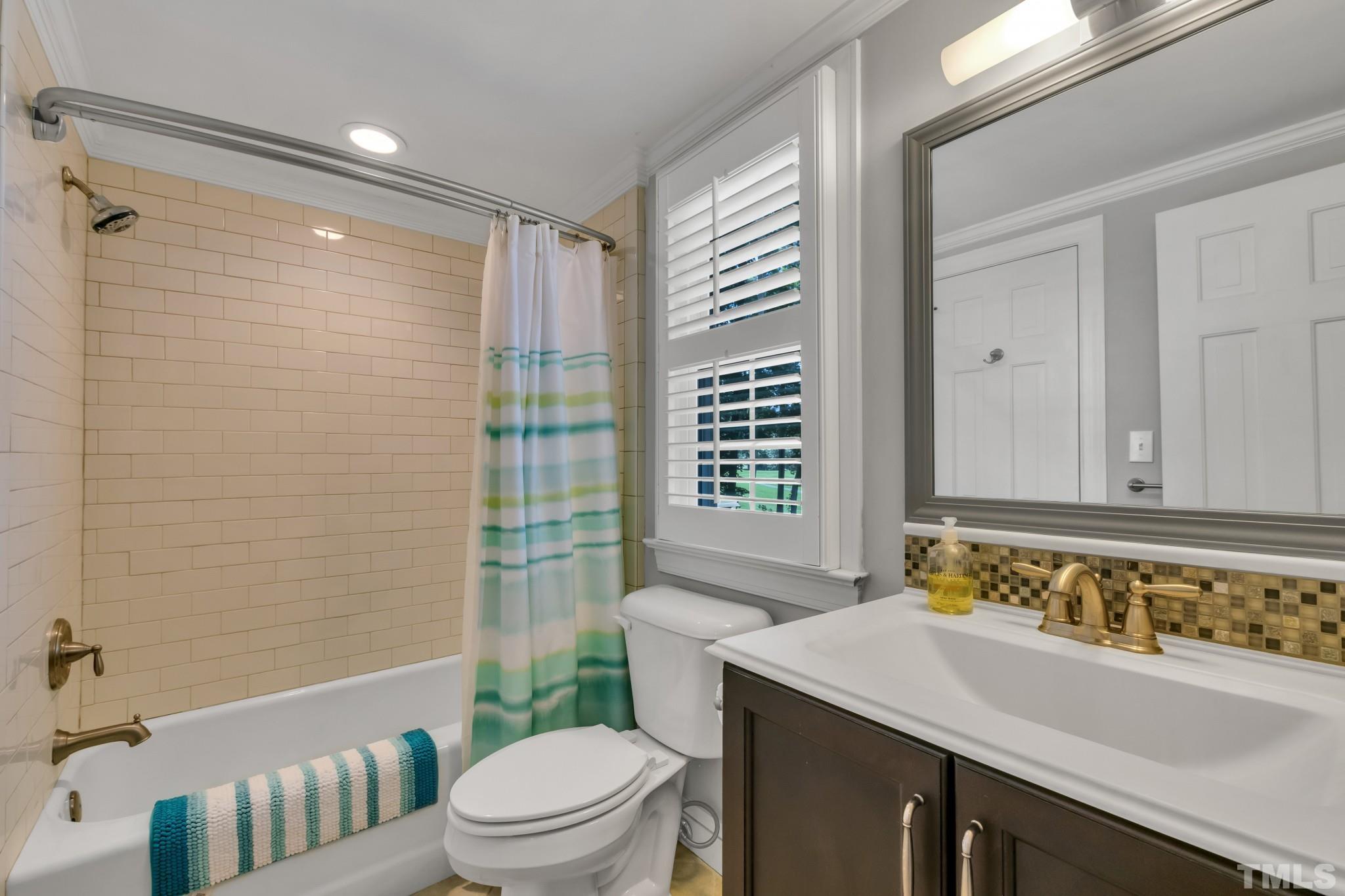 1617 Hunting Ridge Road Raleigh, NC 27615 - Photo 12 of 31 a bathroom with a sink toilet and shower
