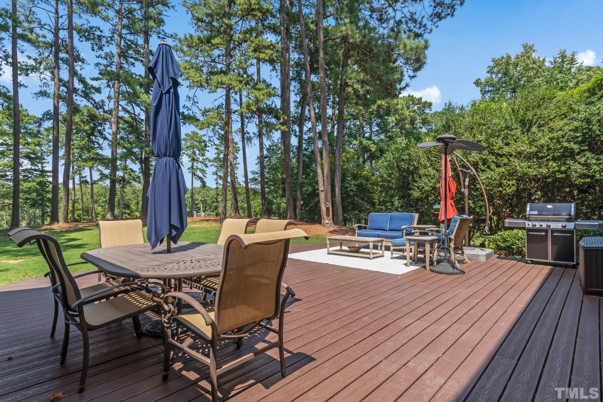 1617 Hunting Ridge Road Raleigh, NC 27615 - Photo 13 of 31 a view of a patio with table and chairs and wooden floor