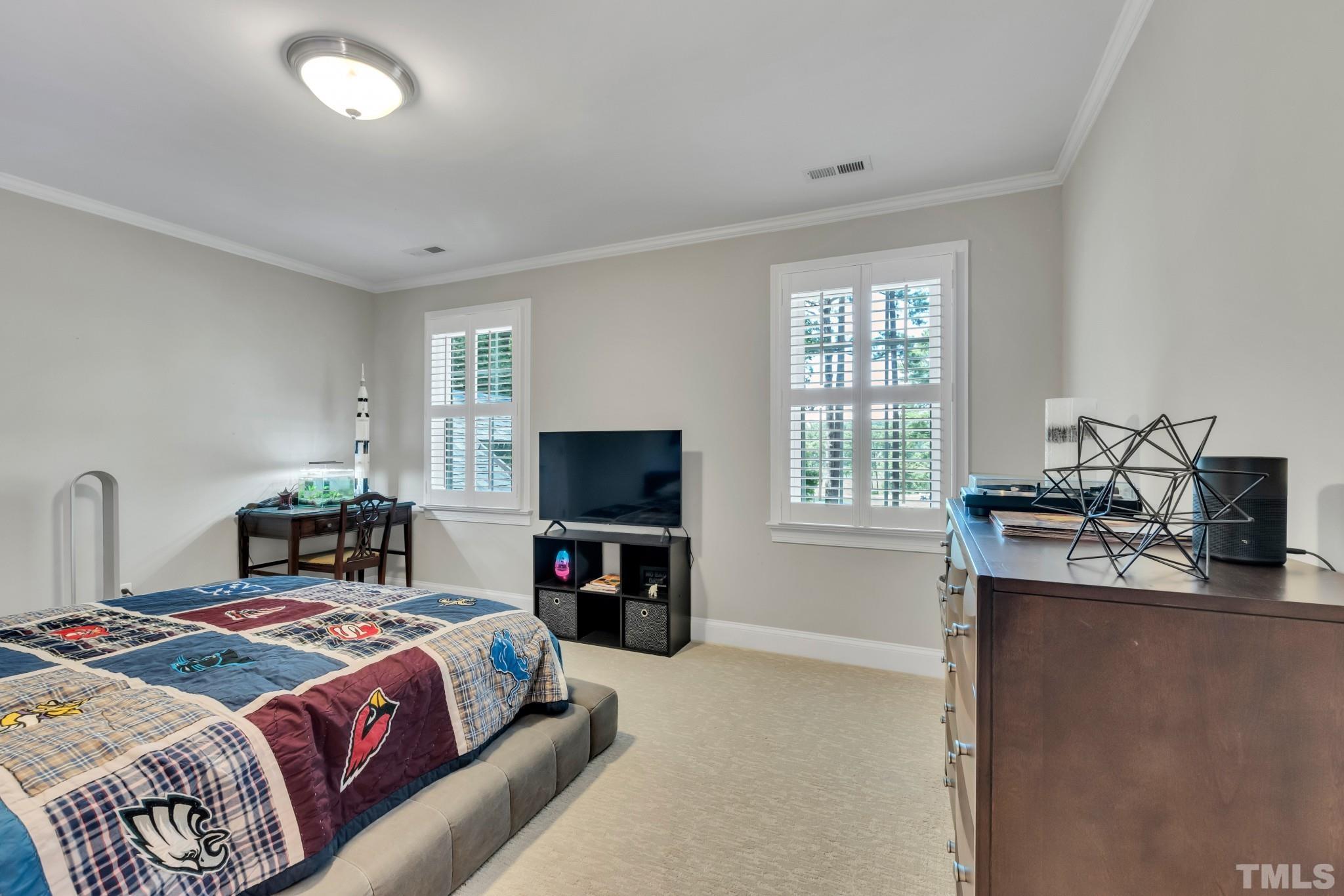 1617 Hunting Ridge Road Raleigh, NC 27615 - Photo 20 of 31 a bedroom with a bed and a flat screen tv