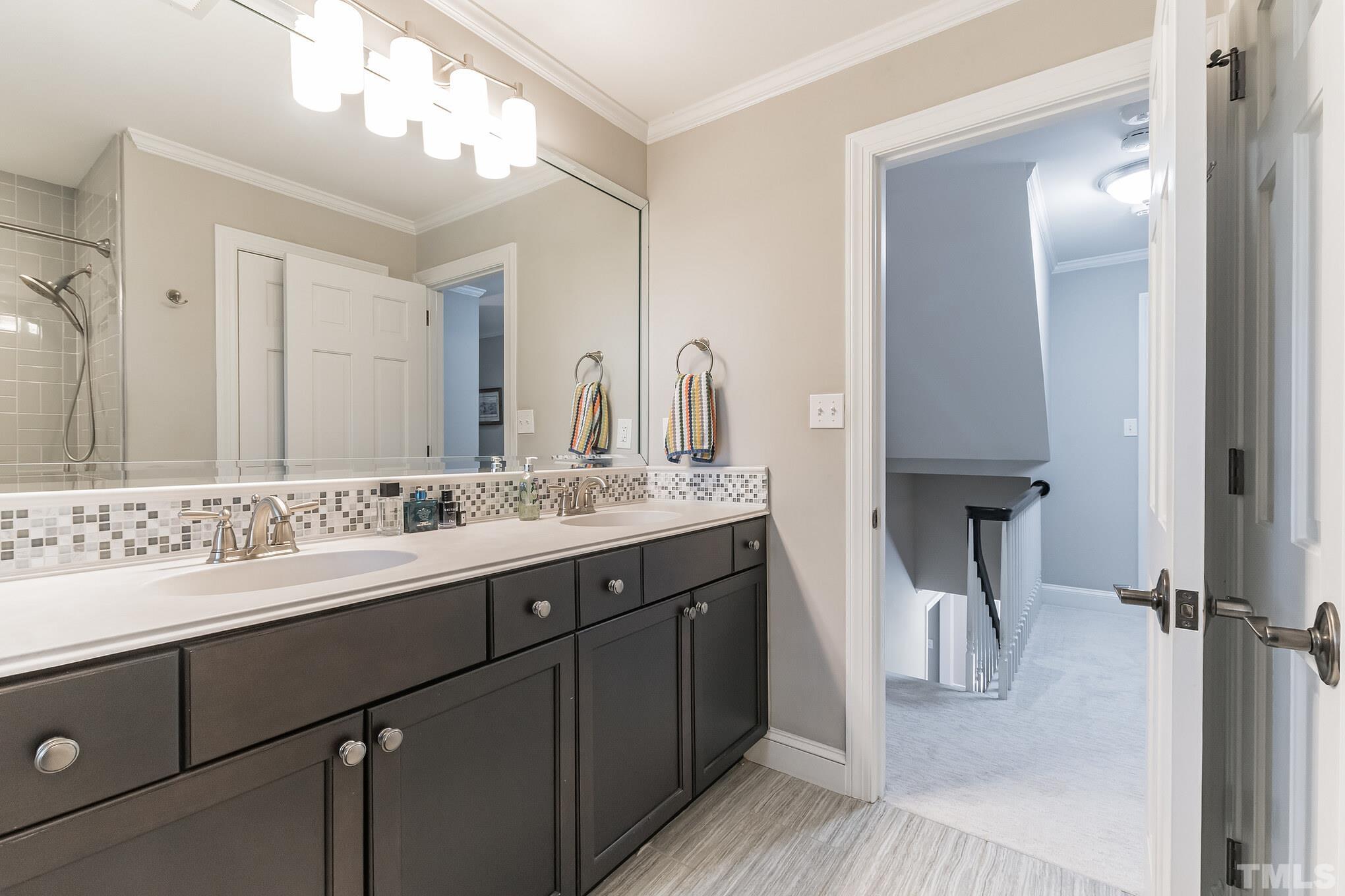 1617 Hunting Ridge Road Raleigh, NC 27615 - Photo 22 of 31 a bathroom with a sink double vanity and a mirror