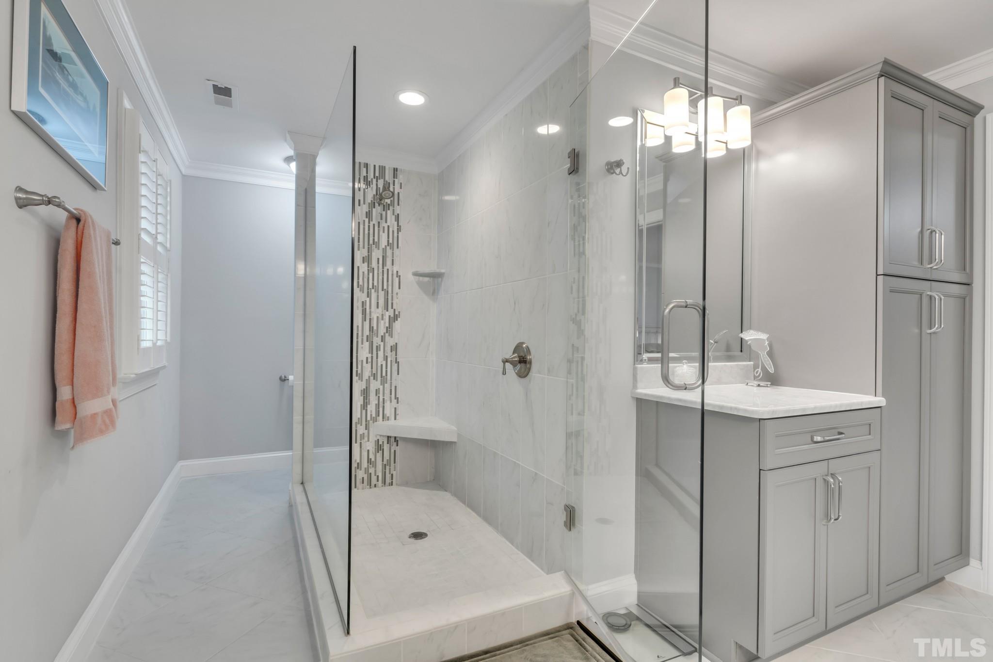 1617 Hunting Ridge Road Raleigh, NC 27615 - Photo 23 of 31 a bathroom with a shower sink and mirror
