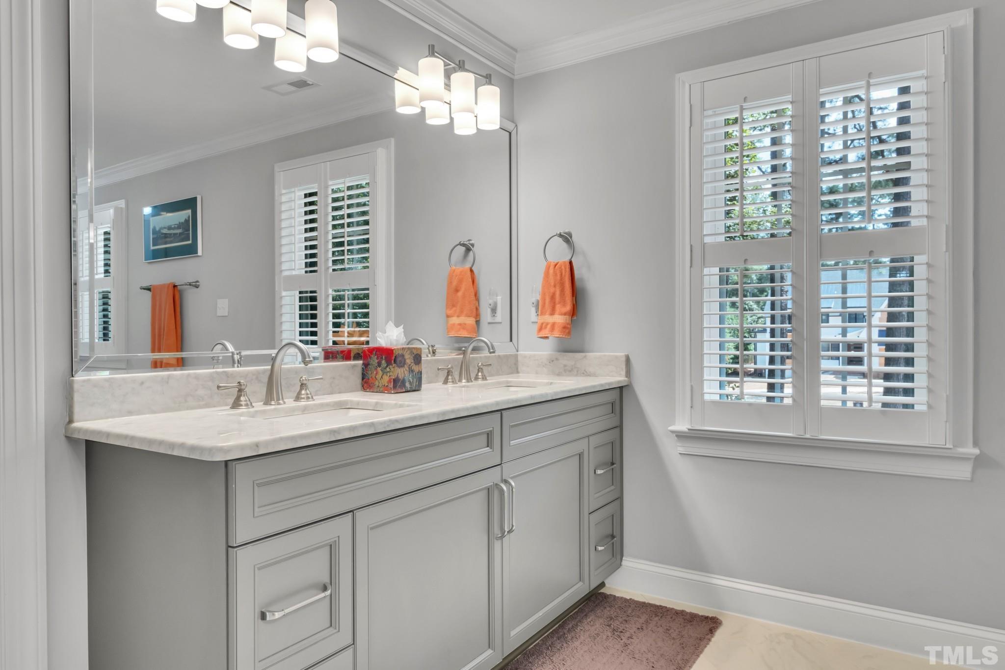 1617 Hunting Ridge Road Raleigh, NC 27615 - Photo 24 of 31 a bathroom with double vanity and a mirror
