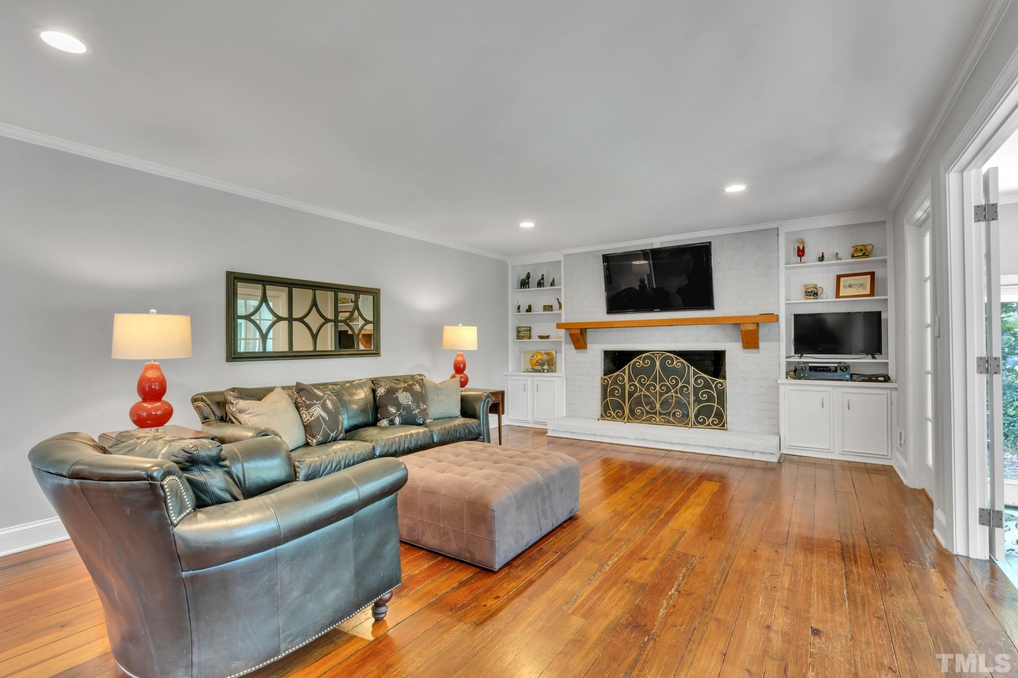 1617 Hunting Ridge Road Raleigh, NC 27615 - Photo 5 of 31 a living room with furniture and a fireplace