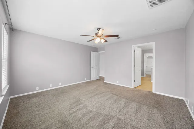 a view of an empty room with a ceiling fan