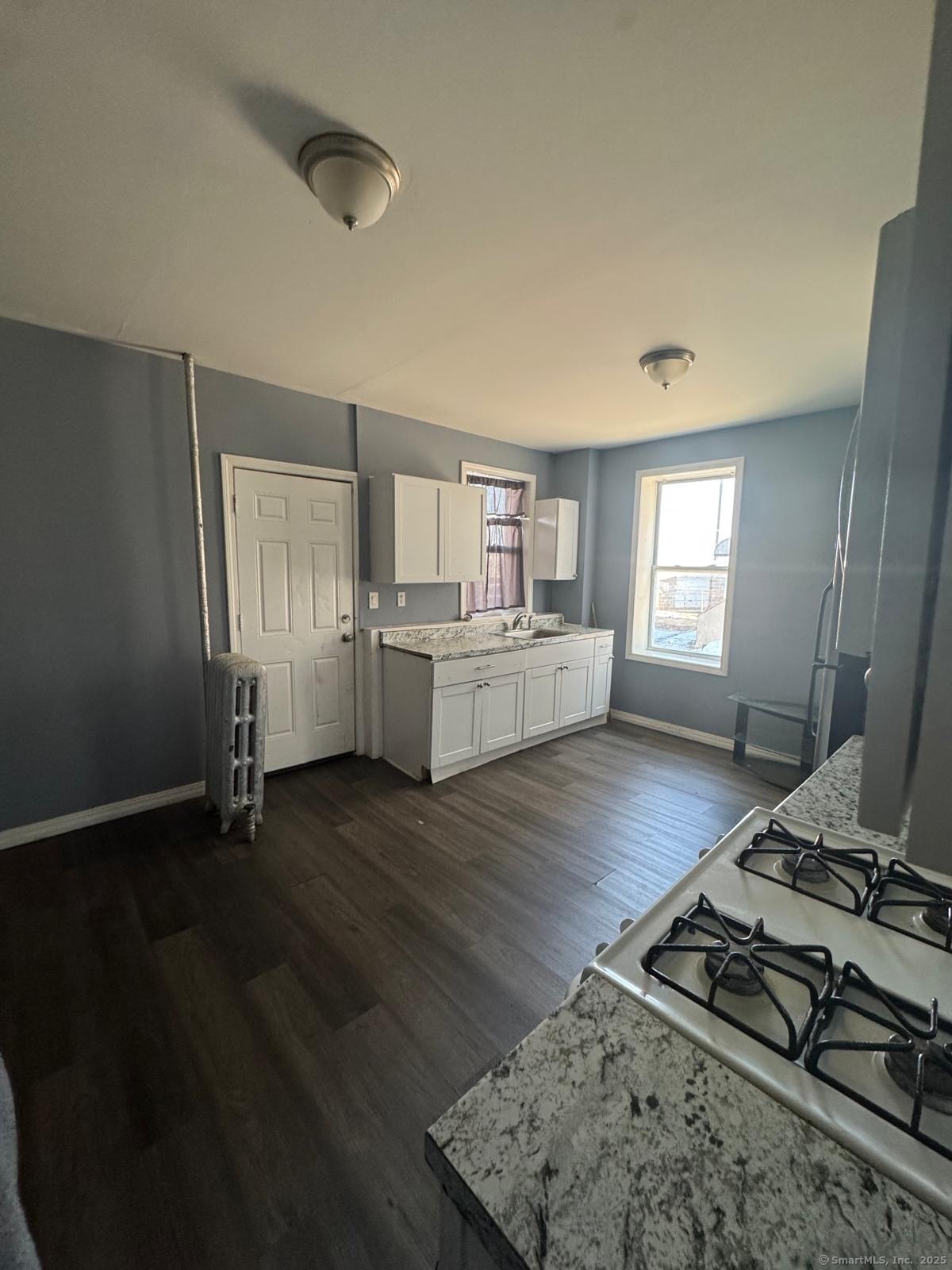 146 George Street, Unit 2 Bridgeport, CT 06604 - Photo 12 of 12 a living room with stainless steel appliances furniture and a wooden floor
