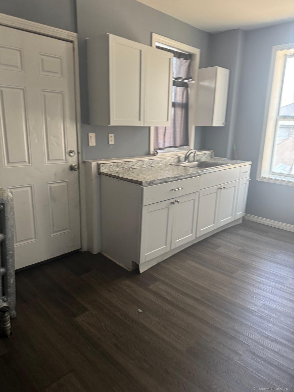 146 George Street, Unit 2 Bridgeport, CT 06604 - Photo 7 of 12 a spacious bathroom with a granite countertop sink and a mirror