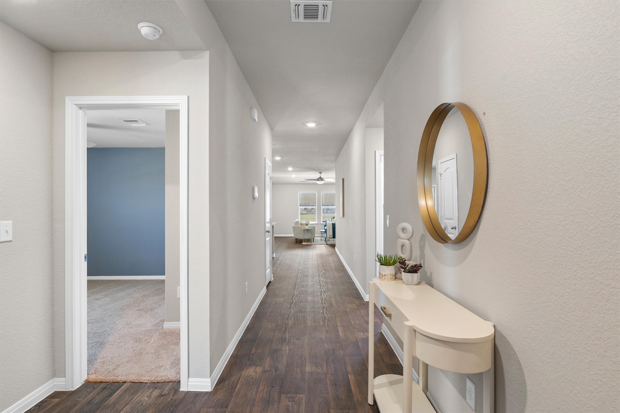 19525 Abigail Fillmore Road Manor, TX 78653 - Photo 6 of 38 Rich hardwood floors guide guests into a naturally illuminated, open-concept living area.