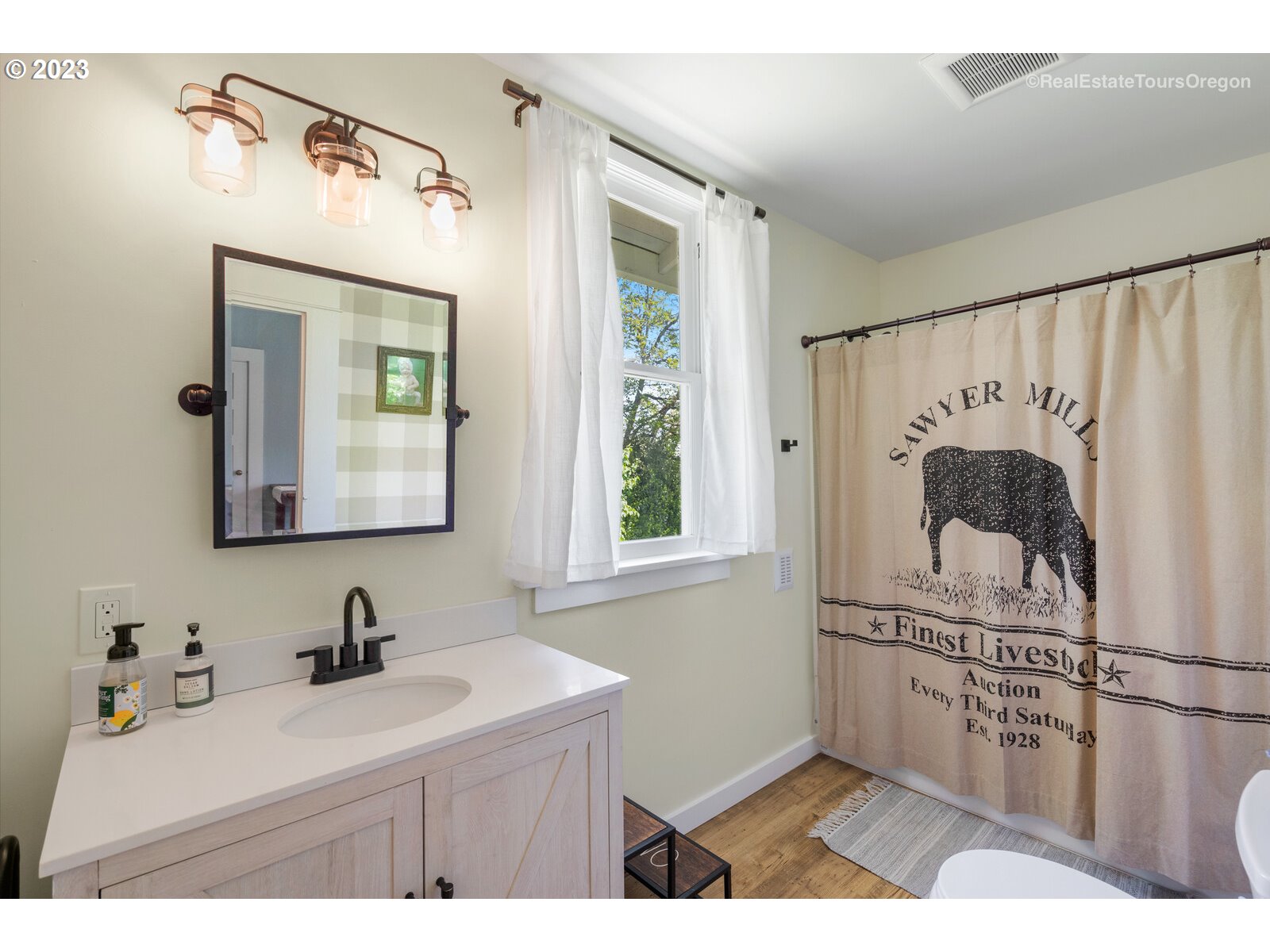 6970 South Knights Bridge Road Canby, OR 97013 - Photo 11 of 32 a bathroom with a sink a mirror and a shower