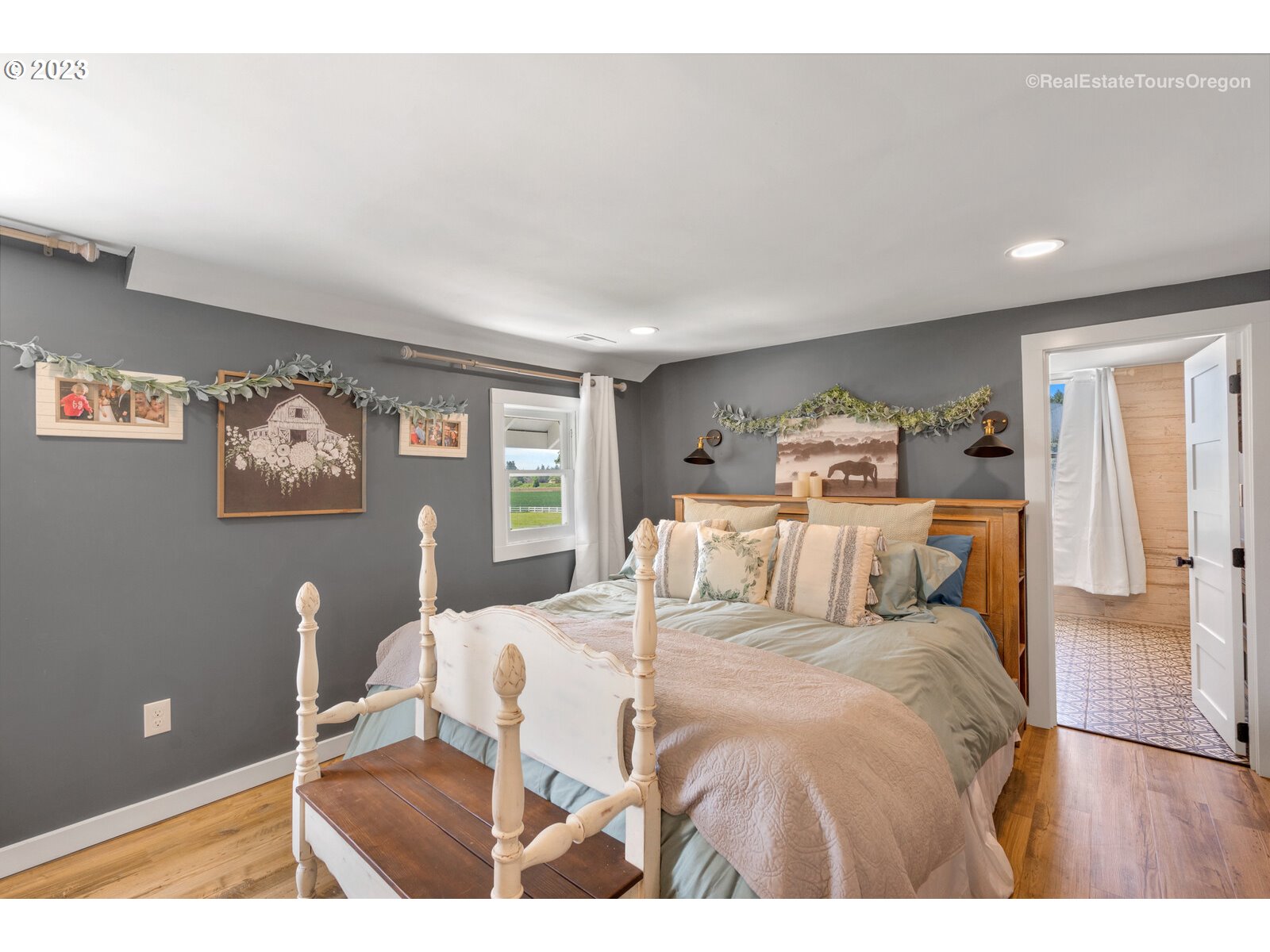 6970 South Knights Bridge Road Canby, OR 97013 - Photo 13 of 32 a bedroom with a bed and painting on the wall