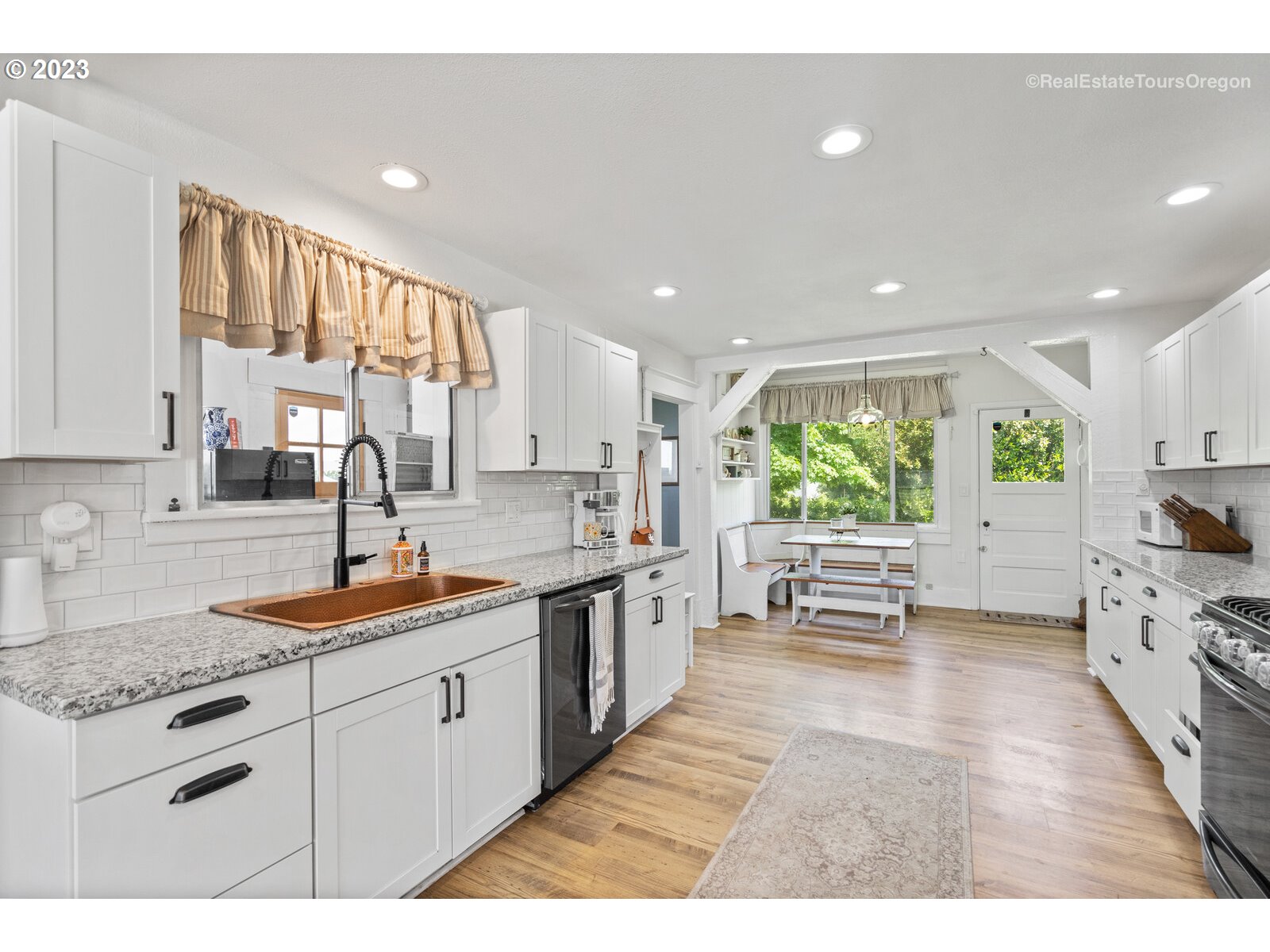 6970 South Knights Bridge Road Canby, OR 97013 - Photo 7 of 32 a kitchen with a sink stove and cabinets