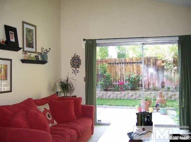 4389 Pescado Way Reno, NV 89502 - Photo 3 of 9 a living room with furniture and a floor to ceiling window