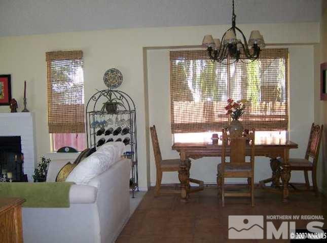 4389 Pescado Way Reno, NV 89502 - Photo 5 of 9 a living room with furniture a chandelier and a large window