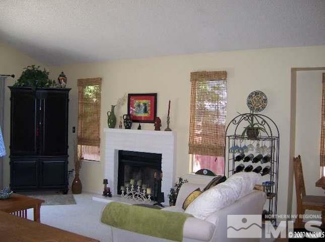 4389 Pescado Way Reno, NV 89502 - Photo 7 of 9 a living room with furniture and a fireplace