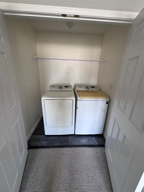 1736 Ransom Terrace Fort Worth, TX 76112 - Photo 24 of 27 Dedicated laundry area with durable dark tile flooring, a built-in storage shelf, and crisp white bi-fold doors