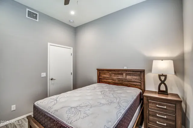 a bedroom with a bed and a lamp