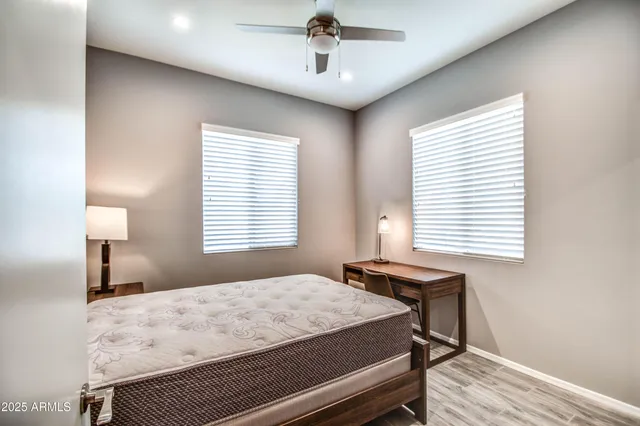 a bedroom with a bed and a window